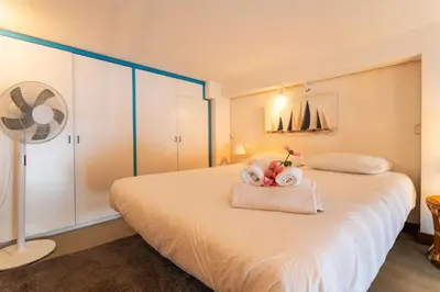 a bedroom with a bed with a view of the ocean at MARINE AP4445 By Riviera Holiday Homes in Villefranche-sur-Mer