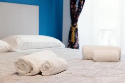 two towels are sitting on top of a bed at Azur BnB in Nice