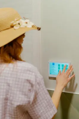 a woman wearing a hat is looking at a monitor at Azur BnB in Nice