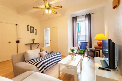 a living room with a couch and a tv at ESCALINADA II AP4433 by Riviera Holiday Homes in Villefranche-sur-Mer
