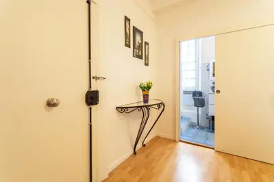 a room with a door and a table with flowers on it at ESCALINADA II AP4433 by Riviera Holiday Homes in Villefranche-sur-Mer