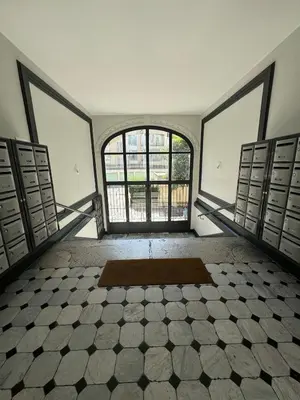 an empty room with a large window and a rug at Studio en plein cœur de Nice in Nice