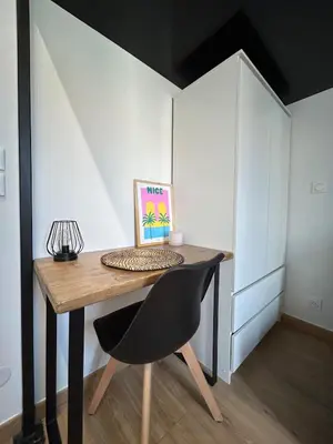 a desk with a chair and a picture on it at Studio en plein cœur de Nice in Nice
