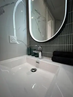 a bathroom with a white sink and a mirror at Studio en plein cœur de Nice in Nice