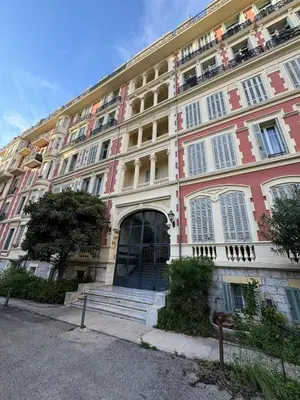a large pink and white building with a door at Studio en plein cœur de Nice in Nice