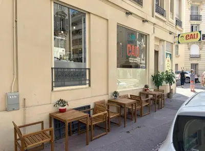 a row of tables and chairs outside of a store at Chic Flat Near the Beach in Nice