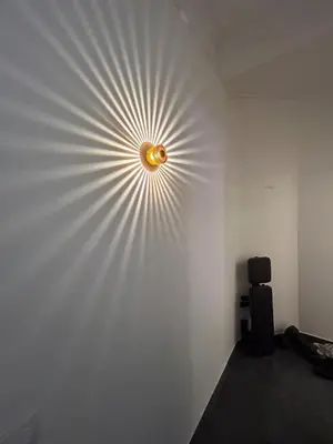 a wall with a circular light on the wall at Chic Flat Near the Beach in Nice