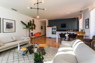 a living room with a couch and a table at PORT LYMPIA AP4429 By Riviera Holiday Homes in Nice