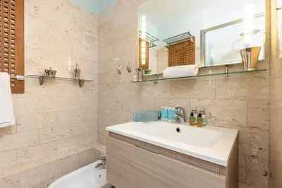 a bathroom with a sink and a toilet and a mirror at MY CASA - MEDECIN 26 - Superb Apt Suite Downtown in Nice