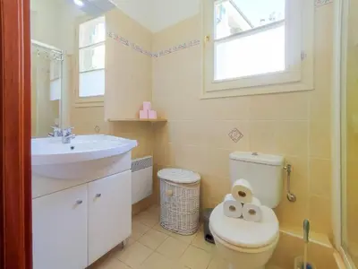 a bathroom with a toilet and a sink and a window at Grimaldi Centrale 3 Pers WiFi AC in Nice