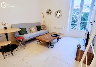 a living room with a couch and a table at Centre-ville Proche gare in Nice