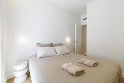 a bedroom with a bed with two towels on it at Maison Galbani Architect-designed apartment in Nice