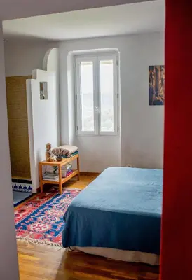 a bedroom with a bed and a window at Village house surrounded by greenery in La Gaude