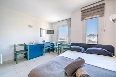 a bedroom with a bed and a table and chairs at Studio hypercentre gare in Nice