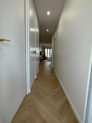 an empty hallway with white walls and wood floors at Beautiful 3 rooms, Carré d 'Or in Nice