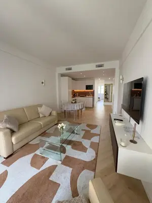 a living room with a couch and a table at Beautiful 3 rooms, Carré d 'Or in Nice