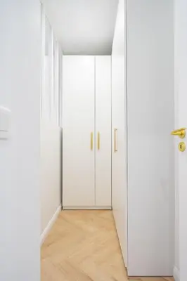 an empty room with white doors and wooden floors at Beautiful 3 rooms, Carré d 'Or in Nice