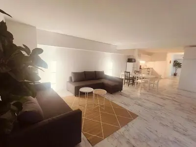 a living room with a couch and a table at Superbe appartement T2 de 95 m in Nice