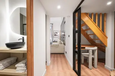 a bathroom with a sink and a staircase in a room at Beautiful apartment, old nice in Nice