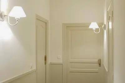 a hallway with a white door and two lights at Barla 1 - a cosy one bedroom apartment in Nice in Nice