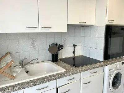 a kitchen with a sink and a microwave at Lympia - one bedroom apartment near the port in Nice