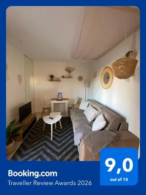a living room with a couch and a table at Studio Boho Chic - Proche de la mer in Nice