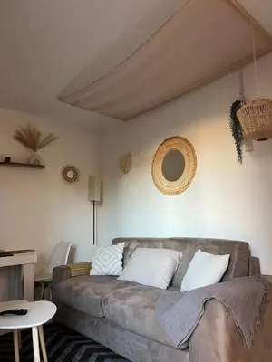 a living room with a couch and a table at Studio Boho Chic - Proche de la mer in Nice