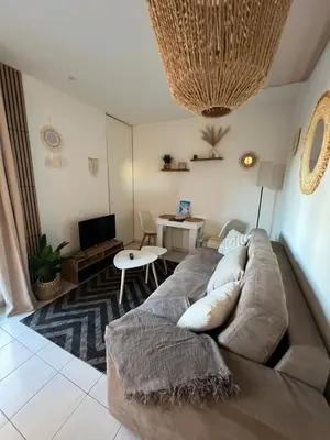 a living room with a couch and a table at Studio Boho Chic - Proche de la mer in Nice