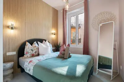 a bedroom with a bed with a teddy bear on it at Nice Renting - 8BONAPARTE - Architect Loft Luxury 4 Bedrooms View Place du Pin in Nice