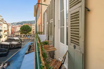 a balcony with benches and shutters on a building at Nice Renting - 8BONAPARTE - Architect Loft Luxury 4 Bedrooms View Place du Pin in Nice