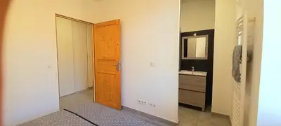 a bathroom with a wooden door and a sink at Appartement au coeur de la ville in Nice