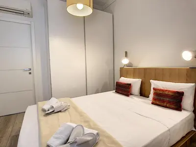 a bedroom with a bed with two slippers on it at Nestor&Jeeves - COTE JARDIN - Central - Close sea in Nice