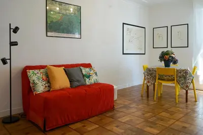 a living room with a red couch and a table at Riviera Prom 4 Pers Vista Mare in Nice