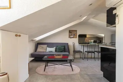 a living room with a couch and a table at Perchoir dans la vieille ville in Nice