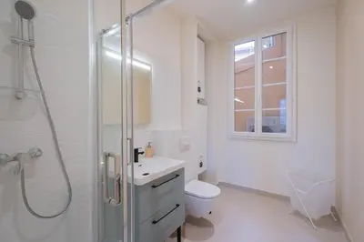 a bedroom with a bed and a large window at Nice - Beautiful bright apartment - 10 min beach in Nice