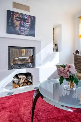 a living room with a glass table and a fireplace at Villa de prestige Vue mer panoramique Piscine Climatisation in Nice