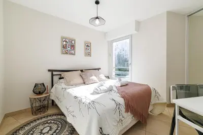 a bedroom with a bed and a window at Nice Luxury in Nice