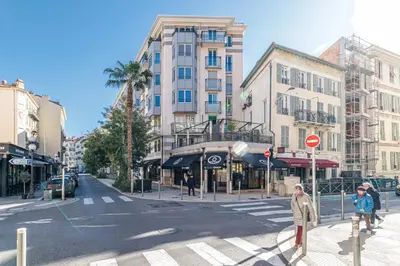 two people are crossing a street in a city at Nice Luxury in Nice