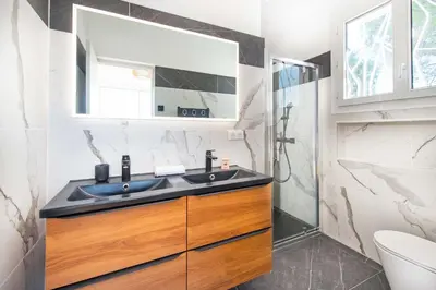 a bathroom with a sink and a shower at Villa Grenouillere - Vue Mer - Fitness - Sauna in Cagnes-sur-Mer