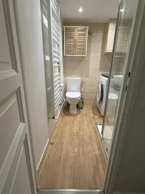 a bathroom with a washing machine and a sink at Studio Sunrise - Jean Médecin in Nice