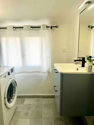 a bathroom with a washing machine and a sink at Charmant studio Vieux Nice in Nice