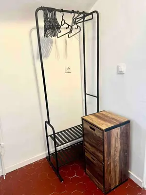 a room with a bench and a dresser next to a wall at Charmant studio Vieux Nice in Nice