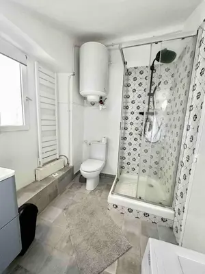a white bathroom with a shower and a toilet at Charmant studio Vieux Nice in Nice