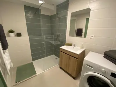 a bathroom with a shower and a sink and a washing machine at Cosy Appartement Vieux Nice in Nice