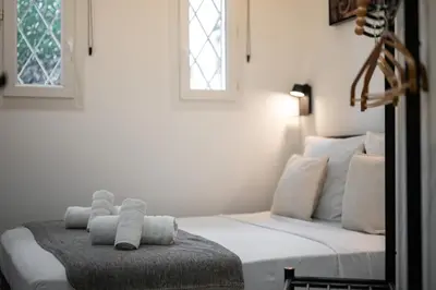 a white bed with a stuffed animal on top of it at Bleu Rivage - Magnifique 2P au Port de Nice - 1 chambre et 1 Mezzanine in Nice