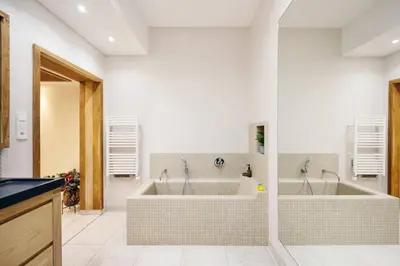 a large bathroom with two sinks and a tub at Elegance, serenite et vue exeptionnelle sur la rade in Villefranche-sur-Mer