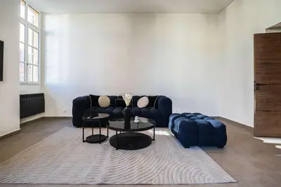 a living room with a couch and a table at Massena Infinity in Nice