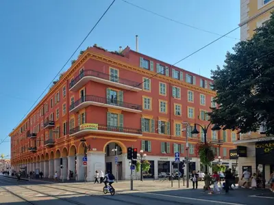 a large red building on the corner of a street at Massena Infinity in Nice