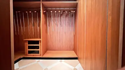 a walk in closet with wooden walls and a shelf at Palm & Sun in Nice