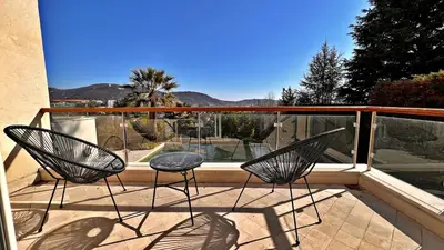 two chairs and a table on a balcony at Palm & Sun in Nice